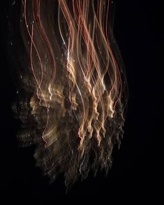 blurry photograph of light streaks in the dark night sky, with long exposures