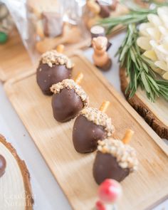 chocolate covered desserts are lined up on wooden trays and ready to be eaten