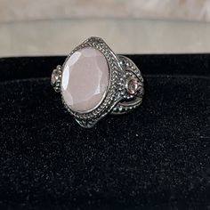 This Magnificent Peach Moonstone Suite Is Handmade In Bali, Using 360 Degrees Of Design. Look Through Each Listing For More Information On This Incredible Natural Gemstone Suite! This Statement Ring Has So Many Intricate Designs Woven With Sterling Silver. You Will Find A High Polish And Braided Bezel That Surrounds A Gigantic Table Cut Genuine Peach Moonstone Gem. For Added Flair, The Peach Moonstone Is Faceted Around The Edges. On The Left And Right Sides Of The Ring, You Will Find Pink Plum Topaz Gemstones Surround In A Halo Of Jawan Beads. The Sides Of The Ring Cascade Into A Tapered Tree Of Life And Jawan Bead Design. The Interior Of The Ring Is Impeccably Detailed. This Ring Has It Bohemian Oval Cabochon Moonstone Ring, Bohemian Hand-forged Sterling Silver Moonstone Ring, Bohemian Silver Oval Cabochon Moonstone Ring, Bohemian Sterling Silver Oval Cabochon Moonstone Ring, Artisan Silver Opal Cabochon Ring, Bali Jewelry, Bali Silver, Gold Flecks, Peach Moonstone