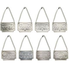 six silver metal signs hanging from chains on a white background, each with the word vodka