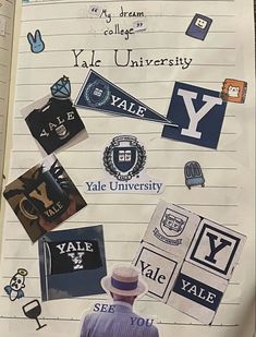 an open notebook with various stickers on the pages, including letters and symbols that spell out y