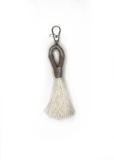 a key chain with a tassel hanging from it's side on a white background