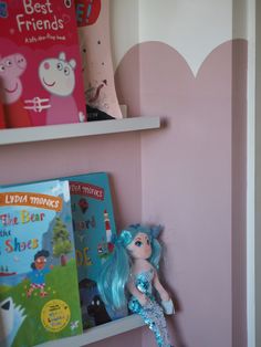 two bookshelves with children's books on them in a child's room