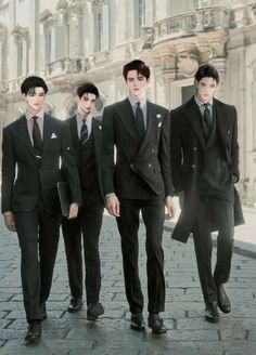 four young men in suits and ties walking down a cobblestone street with buildings in the background