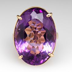 This superb vintage cocktail ring is accented with one (1) oval cut natural amethyst that weighs approximately 22.60cts that is set into a four-prong setting. The gallery features an openwork design. The ring measures 23.9mm at the top, rises 10.5mm above the finger, tapering to 2.6mm wide and 1.5mm thick at the base of the shank. It is currently a size 6.25. Timeless Oval Purple Amethyst Ring, Timeless Purple Oval Amethyst Ring, Heirloom Oval Amethyst Ring For Formal Occasions, Art Deco Oval Amethyst Ring, Oval Amethyst Ring For Formal Occasions, Luxury Purple Amethyst Oval Cabochon Ring, Luxury Polished Oval Amethyst Ring, Luxury Oval Amethyst Ring With Polished Finish, Timeless Oval Purple Jewelry