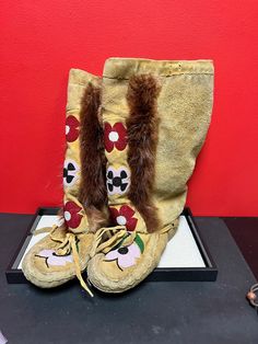 10 x 14 inches high indigenous First Nations leather and beaded moccasin boots  -- fabulous quality and condition -- wow  We sell these for decorative purposes, but if you want to wear them then go ahead This is a really beautiful pair Really great condition for the age Beading is stunning Red Shelves, Moccasin Boots, First Nations, Shelf Decor, Beautiful Shoes, Art Object, Moccasins, Beautiful Necklaces, Sculpture Art