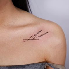 a woman with a tattoo on her shoulder that says, love is in the air