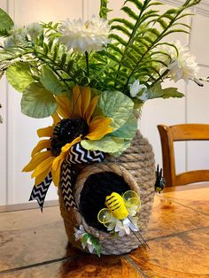 a vase filled with flowers on top of a wooden table