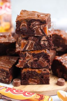 chocolate fudge brownies stacked on top of each other next to a candy bar