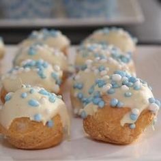 blue and white sprinkles are on top of donuts that have frosting