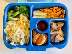 a blue lunch box filled with pasta, meat and veggies