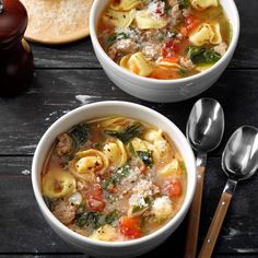 two bowls filled with pasta and meat soup