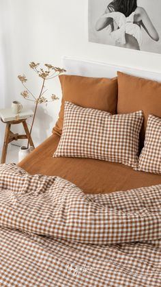 a bed with brown and white checkered sheets