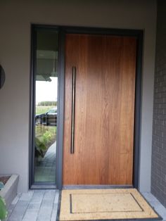 a wooden door is open on the side of a house