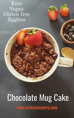 chocolate mug cake with strawberries and chocolate chips on the side, in a bowl