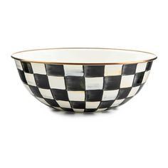 a black and white checkered bowl with gold rim