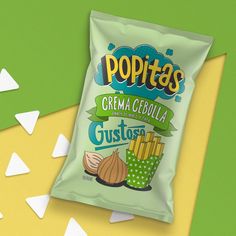 a bag of potato chips sitting on top of a green and yellow background with white confetti sprinkles