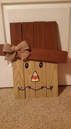 a paper bag with a scarecrow face on it sitting in front of a door