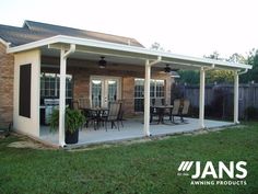 a covered patio with table and chairs on it