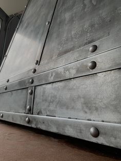 an old metal cabinet with rivets on it