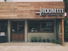 the front of a restaurant with wood siding