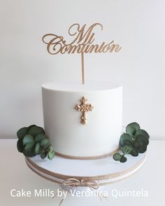 a white cake with a gold cross on top