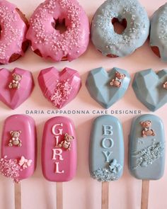 there are many doughnuts on the sticks with fondant letters and teddy bears