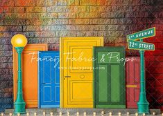 colorful doors and street signs in front of a brick wall