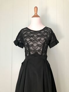 "* 1950s black cocktail dress * full pleated taffeta skirt * pointed inverted basque waist * sheer double layer lace bodice * short sleeves with taffeta cuffs and bows * scoop neck * low v-back * back metal zipper with series of hooks and eyes ✂ Measurements Bust: 36\"-37\" (dolman sleeves) Waist: 23\"-23.5\" (maybe a very snug 24\") Hips: free Shoulder to waist: 15\" Waist to hem: 26.5\" Length: 41.5\" Fits like: extra small Condition: Good. Some small breaks in the lace on the bodice - these w Basque Waist, Lbd Dress, Floral Embroidery Dress, Taffeta Skirt, 80s Dress, Vintage Short, 50s Dresses, Black Cocktail, Lace Bodice