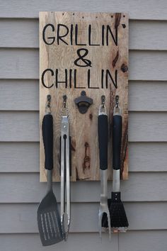 a sign that says grillin and chillin hanging on the side of a house