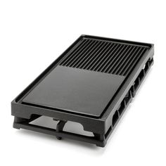 a black grill sitting on top of a white surface