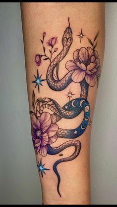 a woman's leg with a snake and flowers on it