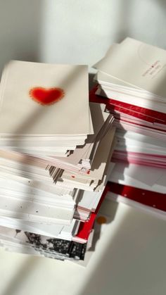 a stack of papers with red ink on them