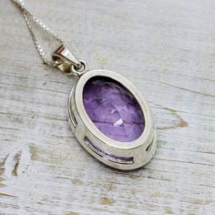 "Stunning Amethyst pendant cushion cut flat top oval shape light purple clear natural Amethyst stone set on 925 solid sterling silver unisex Amazing quality 925e sterling silver hypoallergenic and nickel free Dimensions Stone Only : 26 x 18 mm Length with silver bail : 40 mm (1.58\") Width : 19.3 mm (0.76\") Height : 10 mm Weight : 11.1 925 sterling Silver chain available starts at $10 USD from 16\" to 30\"" Amethyst Oval Pendant Jewelry For Anniversary, Faceted Oval Sterling Silver Gemstones, Oval Silver Amethyst Gemstones, Large Oval Amethyst Stone Jewelry, Oval Faceted Sterling Silver Gemstone, Oval Purple Gemstones For Gifts, Oval Amethyst Jewelry With Polished Finish, Purple Oval Sterling Silver Gemstones, Polished Oval Amethyst Jewelry