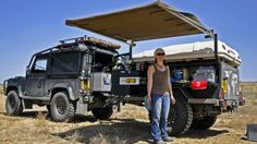 a woman standing in front of an off road vehicle