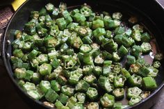 green peppers being cooked in a skillet