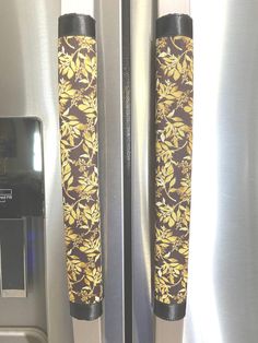 a close up of the door handles on a refrigerator with floral fabric wrapped around it