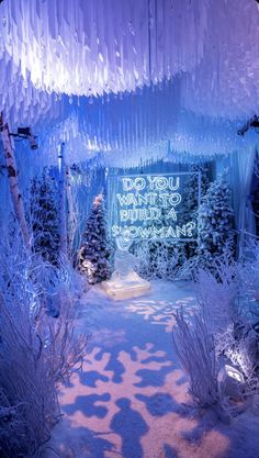 the entrance to an ice cave with snow and icicles hanging from it's ceiling