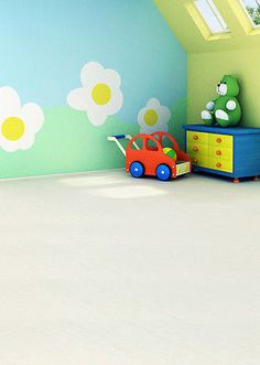 a child's room painted in blue, green and yellow with flowers on the wall