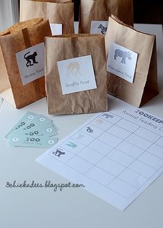 four brown paper bags sitting on top of a table next to a calendar and other items