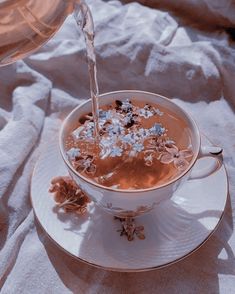 a cup filled with hot chocolate and topped with flowers