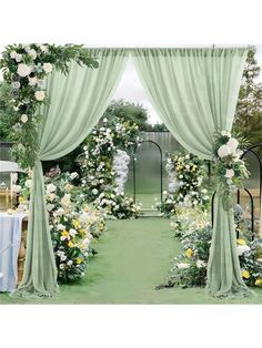 an outdoor wedding ceremony with flowers and greenery on the aisle, draped in light green fabric