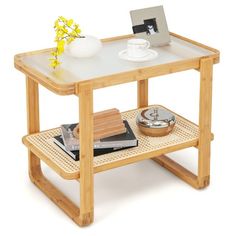 a wooden table with a glass top and shelf for books, magazines or other items