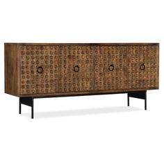 Available online only. The Swanston Credenza is a one-of-a-kind artistic piece that elevates the beauty of any home. Dimple designed fronts Four doors with soft-closing hinges Metal ring pulls One fixed shelf in each cabinets Ventilated back Slim Iron legs Max TV size: 65"  Shown In Natural Material Detail Mango Wood, Iron Leg Finish Black Dimensions 67"w 17"d 30"h Solid Wood Tv Stand, Sale Home, Hardware Pulls, Tv Stand Wood, Hooker Furniture, High Fashion Home, Media Console, Home Entertainment, Brown Wood