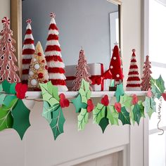 a mantel decorated with christmas trees and candy canes