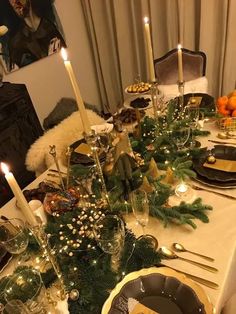 the table is set with candles and plates