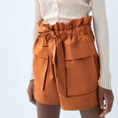 High-Waist Bermuda Shorts Featuring Front Patch Pockets With Flaps. Tied Belt In The Same Fabric. Beautiful Burnt Orange Color. I Wish They Fit Me! Too Large. Materials Outer Shell 97% Cotton 3% Elastane Casual Belted Bottoms With Paperbag Waist, Casual Paperbag Waist Belted Bottoms, Casual Belted Paperbag Waist Bottoms, Chic Tie Waist Bottoms For Fall, Chic Paperbag Waist Bottoms With Tie, High Waist Shorts With Pockets For Fall, Belted Paperbag Waist Shorts, Casual Short Belted Bottoms, Chic Paperbag Waist Shorts With Tie