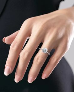 a woman's hand with a diamond ring on it