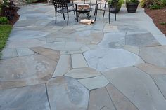 an outdoor patio with chairs and fire pit