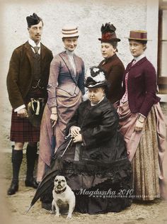 a group of people standing next to each other in front of a building with a dog